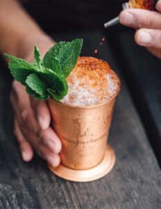Mint julep cocktail served in a traditional copper cup