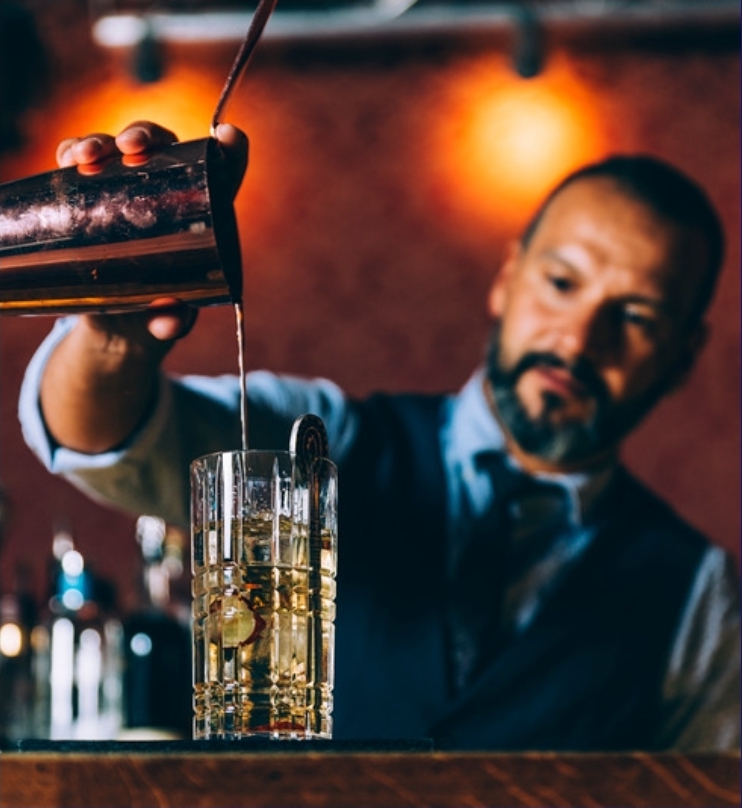 Professional mobile bartender mixing drinks at upscale event