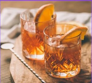Signature cocktail served in old fashioned glass with garnish