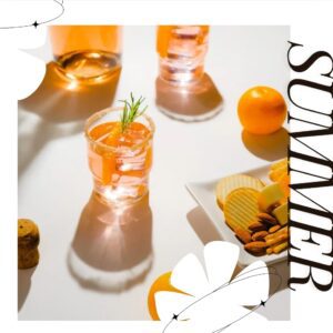 Summer citrus cocktail paired with a snack board and fresh oranges
